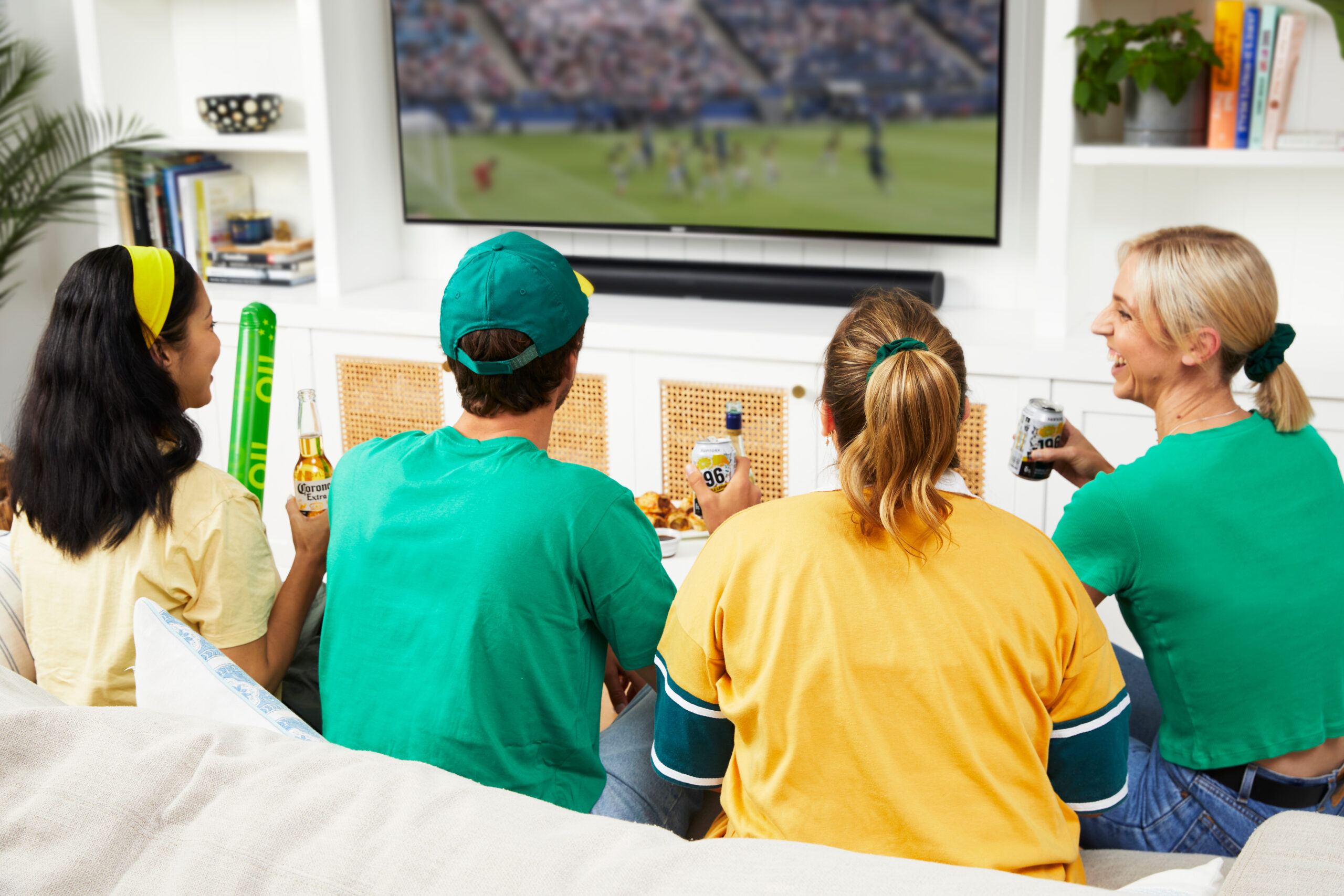 Group of people watching sports on TV
